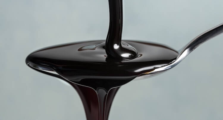 Molasses dripping off a spoon